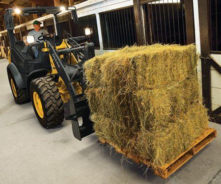 Compact Loader moving hay bales