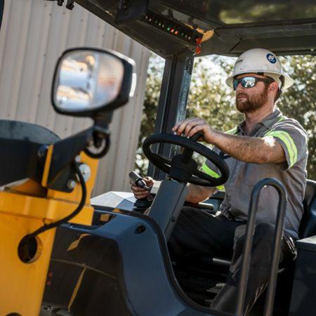 Operator running a compact wheel loader